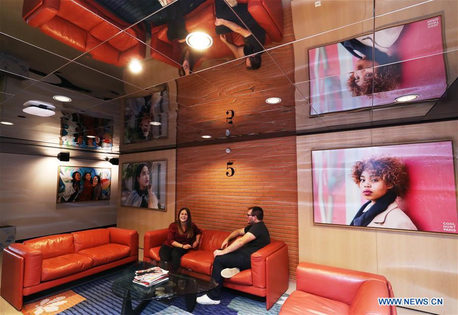 People sit on sofa at the corridor inside the headquarters of L'Oreal in Clichy, suburban Paris, capital of France, Oct. 24, 2019. L'Oreal will participate in the second China International Import Expo (CIIE) scheduled for Nov. 5-10 in Shanghai, east China. (Xinhua/Gao Jing)