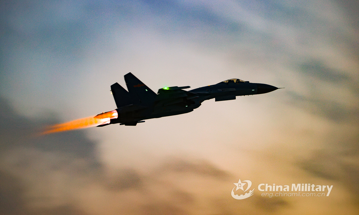 A fighter jet attached to an aviation brigade under the PLA Air Force soars into the sky in a flight training exercise on March 8, 2022. (eng.chinamil.com.cn/Photo by Cui Baoliang)